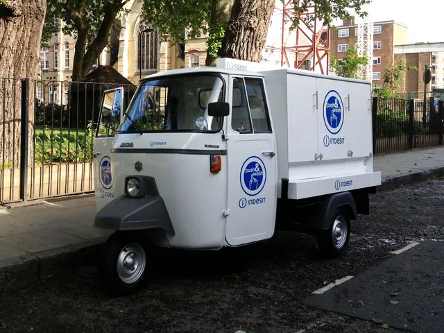 A Piaggio Ape with a fully enclosed, custom-branded box body