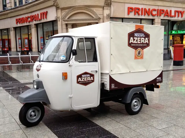 A custom-branded Piaggio Ape coffee unit parked in a shopping precinct
