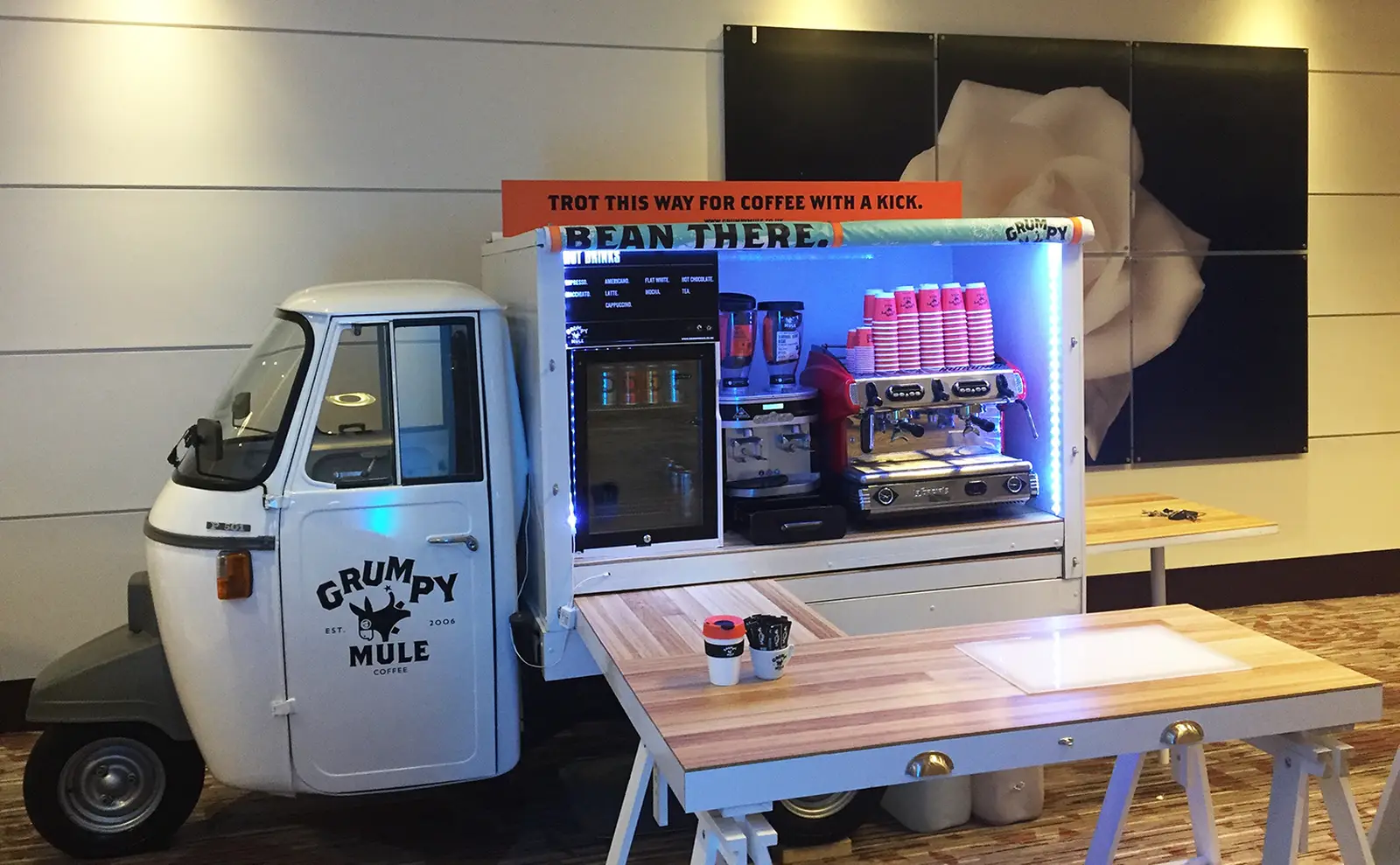 A fully converted Piaggio Ape coffee unit, kitted out with an espresso machine and serving hatch